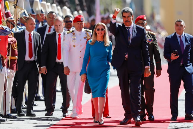 Venezuelan President Nicolas Maduro and his wife Cilia Flores arrive at the National Assembly for his swearing-in ceremony for a third term in Caracas, Venezuela, Friday, Jan. 10, 2025. (AP Photo/Cristian Hernandez)