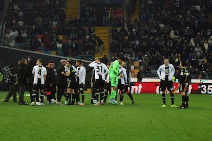 Referee Enzo Maresca, eight from left, match officials, right, and Udinese's players gather as the Italian Serie A soccer match between Udinese and AC Milan is suspended, at the Friuli stadium in Udine, Italy, Saturday, Jan. 20, 2024.