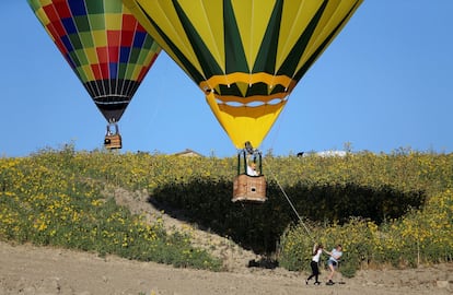 Dos mujeres empujan uno de los globos aerostáticos durante un evento en Todi (Italia).