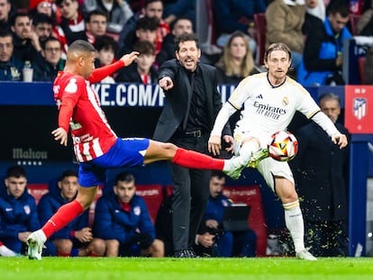 Lino y Modric disputan un balón durante el encuentro de esta noche, con Simeone de fondo.
