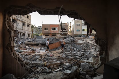 Dos palestinos inspeccionan su casa, atacada por un ataque aéreo israelí, en Gaza.