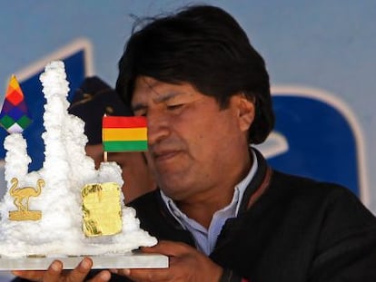 Evo Morales holds a present from a worker at a lithium plant.