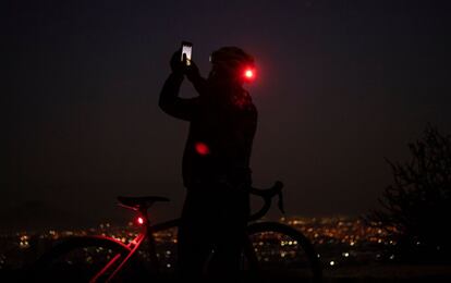 Um ciclista tira uma foto do eclipse lunar esta manhã em Santiago do Chile.