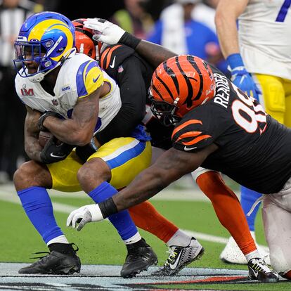 Los Angeles Rams running back Cam Akers, left, is tacked by Cincinnati Bengals strong safety Vonn Bell, middle, and nose tackle D.J. Reader during the first half of the NFL Super Bowl 56 football game Sunday, Feb. 13, 2022, in Inglewood, Calif. (AP Photo/Lynne Sladky)