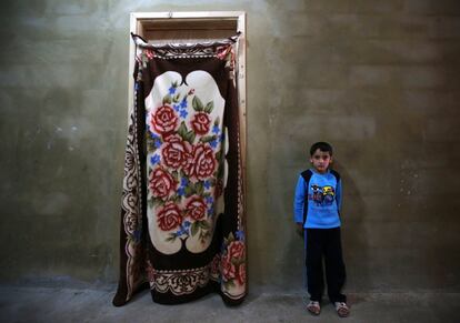 FILE - In this May 29, 2014, file photo, a Syrian refugee boy stands outside his family room at a collective center, in Kirbet Daoud village in Akkar north Lebanon. The U.N. agency for children says more than 80 percent of Syria's children have been harmed by the five-year-old conflict, including growing numbers forced to work, join armed groups or marry young because of widening poverty. (AP Photo/Hussein Malla, File)