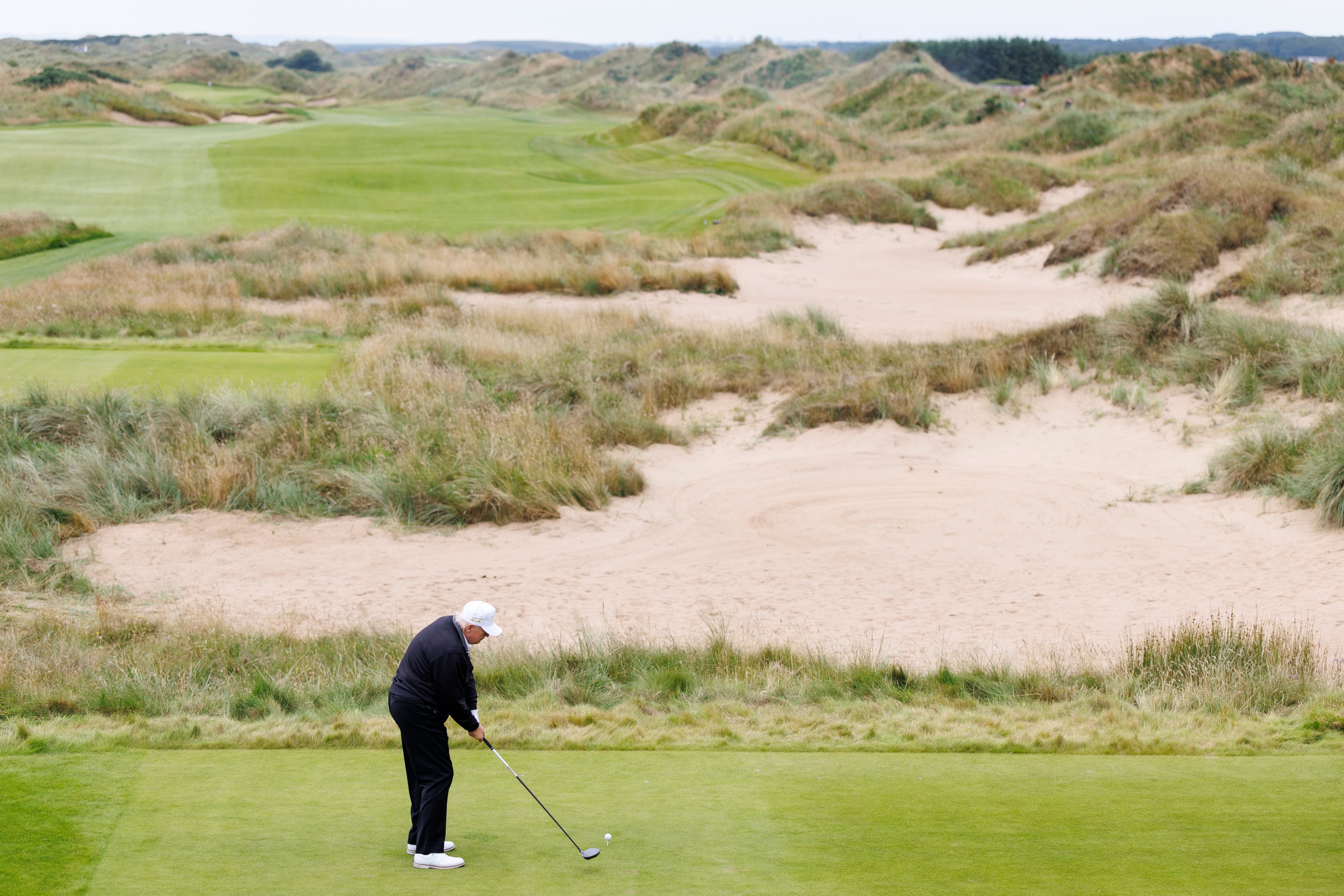 Trump juega al golf en su resort en Escocia.
