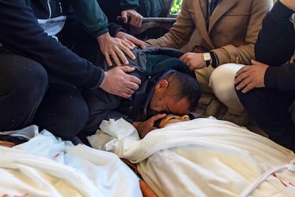 A man cries near a child killed in Israel's attack on an internally displaced persons camp in the Al-Mawasi area, near Khan Younis.