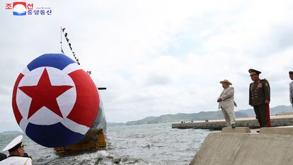 El líder norcoreano, Kim Jong-un (a la izquierda, con sombrero) supervisa la puesta a flote de un nuevo submarino con capacidad nuclear, en el astillero de Sinpho, el miércoles.