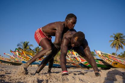 Dos hombres practican lucha senegalesa en una de las playas de Dakar, capital del país.