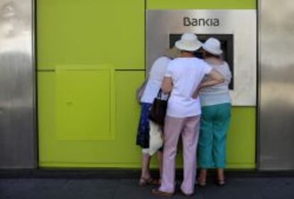 Unas clientes sacan dinero de un cajero de Bankia