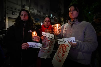 Three women hold up the names of the victims in Plaza Colombia, in Buenos Aires, on May 13.