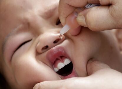 Un bebé toma una vacuna en un centro de salud en Makati (Filipinas).
