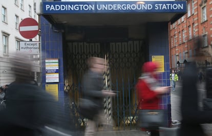 Commuters at Paddington walk past a shuttered entrance to the Underground on the second day of a strike by staff of the London Underground, in London, Thursday, Feb. 6, 2014.  London commuters faced long delays and massive disruptions after subway workers walked off the job to protest upcoming job cuts.  (AP Photo/Alastair Grant)