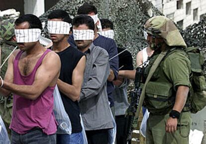 Un soldado israelí conduce a un grupo de palestinos cerca de Belén.