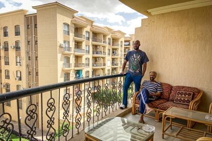 Nageeb Khalifa and his son Ashraf rest on the balcony of their spacious apartment in Al Rehab, the "New Cairo".