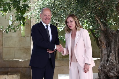 Italian Prime Minister Giorgia Meloni greets German Chancellor Olaf Scholz upon his arrival at the G7 summit in Borgo Egnazia. 
