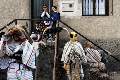 Un grupo de jóvenes de Navalosa, municipio de Ávila, visten la tradicional máscara y traje de "Cucurrumacho", después de uno de los desfiles.