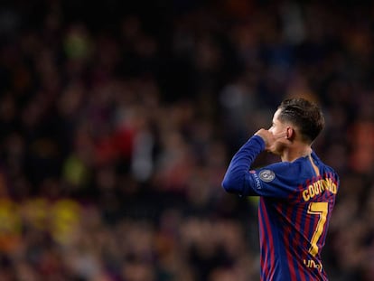 Coutinho plugs his ears and looks up at the Camp Nou terraces after scoring against United.