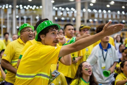 A man gestures towards the screen during a match.