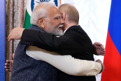 Putin, right, embraces Indian Prime Minister Narendra Modi.