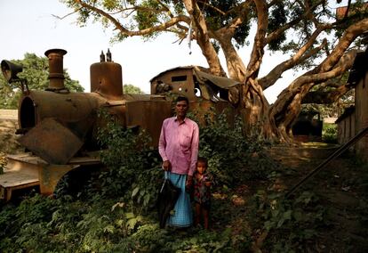 Train driver Rafid Kabadi, 49, poses for a photograph with his grandson in front of an abandoned train that he used to drive in Janakpur, Nepal, June 4, 2017. REUTERS/Navesh Chitrakar  SEARCH "CHITRAKAR RAILWAY" FOR THIS STORY. SEARCH "WIDER IMAGE" FOR ALL STORIES.