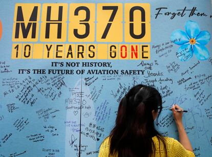 A woman writes well messages on the message board during the tenth annual remembrance event at a shopping mall, in Subang Jaya, on the outskirts of Kuala Lumpur, Malaysia, Sunday, March 3, 2024.