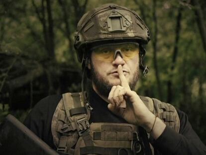 In this image made from video provided by Ukrainian Defense Ministry on Sunday, June 4, 2023, a Ukrainian soldier poses for the camera with his fingers to his lips, in an undisclosed location in Ukraine.