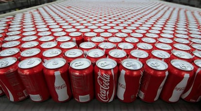 Cans of Coca- Cola Co soda move along a conveyor belt at the company' s Swire bottling plant in Salt Lake City Utah