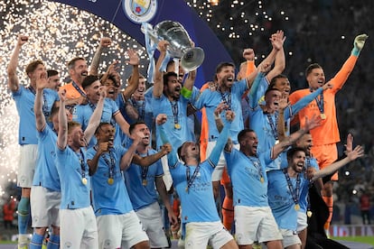 Manchester City's Ilkay Gundogan holds up the trophy after winning the Champions League final soccer match between Manchester City and Inter Milan at the Ataturk Olympic Stadium in Istanbul, Turkey, Sunday, June 11, 2023.