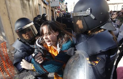 Police in Valencia arrest a girl on Friday during the student protest.