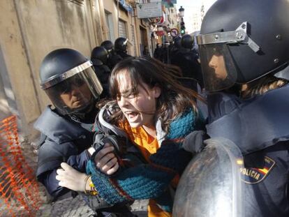 Police in Valencia arrest a girl on Friday during the student protest. 