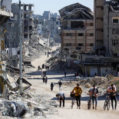 Palestinians make their way in a devasted neighborhood, amid the ongoing Israel-Hamas conflict, in Gaza City, October 24, 2024. REUTERS/Dawoud Abu Alkas