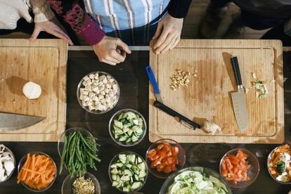 Una tabla de cortar con vegetales en una clase de cocina.