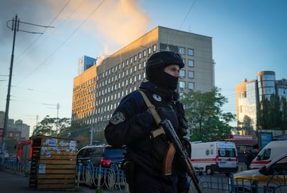 Police block the perimeter at the scene of Russian shelling in Kyiv on Monday.