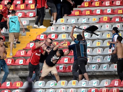 Aficionados de Querétaro se enfrentan a los de Atlas, este sábado, durante un partido de la Liga MX.