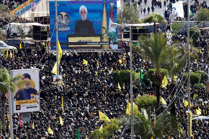 Lebanon's Hezbollah leader Sheikh Naim Qassem appears on a screen as people gather to watch the public funeral ceremony of Hezbollah leaders Hassan Nasrallah and Hashem Safieddine, who were killed in Israeli airstrikes last year, on the outskirts of Beirut, Lebanon February 23, 2025.