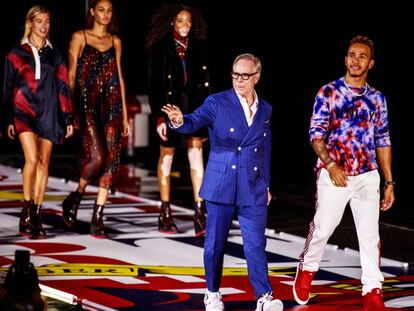 Tommy Hilfiger y Lewis Hamilton saludan tras acabar su desfile en Shanghái, China, el 4 de septiembre.