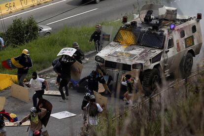 Un vehículo blindado atropella a un grupo de manifestantes durante una protesta contra el Gobierno de Nicolás Maduro, este martes en Caracas.