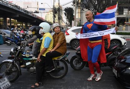 El tailandés-alemán David Pfizenmaier vestido con un traje de Superman, sostiene un cartel que alienta a los tailandeses a votar en las próximas elecciones en Bangkok.
