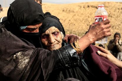Displaced Iraqi women, who just fled their home, rest in the desert as they wait to be transported while Iraqi forces battle with Islamic State militants in western Mosul, Iraq, February 27, 2017. Zohra Bensemra: "I took this picture in a desert on the outskirts of Western Mosul of 90-year-old Khatla Ali Abdallah after she fled the battle for Mosul. Her fearful eyes red with fatigue, Khatla was so exhausted she could not stand or even sit properly. She looked to me like she had not eaten or drank water for a long time. The moment was so emotional that I had tears in my eyes when I photographed Khatla. I felt bad because I could not do anything for her apart from taking pictures to show the world the agony and torment of people trying to flee Mosul to safety.Ê I was sad too, imagining this woman as my own grandmother and feeling helpless to make her comfortable.Ê When you face such a moment, you always think that it could happen to anyone of us. But despite all, Khatla looked beautiful to me, almost as if every wrinkle on her face told a story.Ê I was fortunate to find her a few days later in a refugee camp after showing people my photograph of her.  She has survived decades of turbulence in northern Iraq. She told me "the fighting there is the worst I have ever seen". She had been carried across the desert by her grandsons, under sniper and mortar fire, one of thousands who braved the difficult and dangerous journey out of Islamic State's shrinking stronghold in western Mosul. Khatla made me smile when she expressed her remorse about her 20 chickens she had to leave behind. She had looked after them even while hiding from crossfire in her house's basement. Despite all the terror she experienced under IS rule, it had not destroyed her humanity - she said, 'Even animals deserve life.'" REUTERS/Zohra Bensemra/File photo        SEARCH "MOSUL PICTURES" FOR THIS STORY. SEARCH "WIDER IMAGE" FOR ALL STORIES.