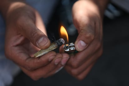 Un consumidor de marihuana encendiendo un porro