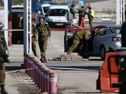 Soldados israel&iacute;es junto al cuerpo de un palestino que dispar&oacute; el pasado domingo en el paso militar Beit El, cerca de Ramala.