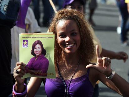 Una mujer muestra un cartel electoral de Margarita Cede&ntilde;o, actual primera dama y candidata a vicepresidenta.