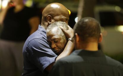 Dos vecinos se abrazan tras el tiroteo en Charleston.