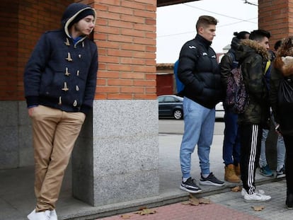 People wait outside the home of the accused soccer players on December 13.