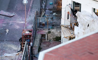 Agentes de los Mossos d’Esquadra intentan acceder a uno de los edificios okupados mientras un activistas les tira pintura desde una ventana.