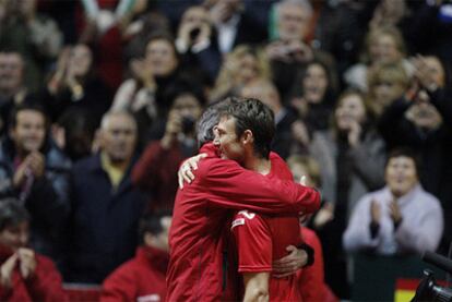 El seleccionador Corretja abraza a Ferrero tras ganar el partido.