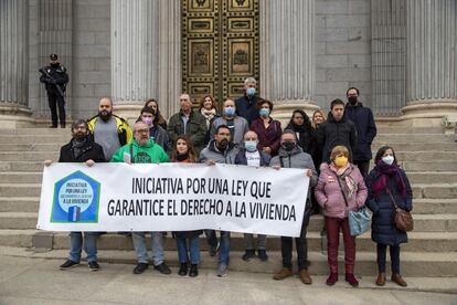 Miembros de la Iniciativa por una ley que garantice el derecho a la vivienda y representantes de los grupos parlamentarios que les apoyan, este jueves ante la puerta del Congreso.