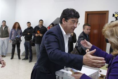 El candidato de IU saluda a una miembro de la mesa electoral de su localidad natal, Bollullos Par del Condado (Huelva). Viajará a Sevilla para seguir los resultados.
