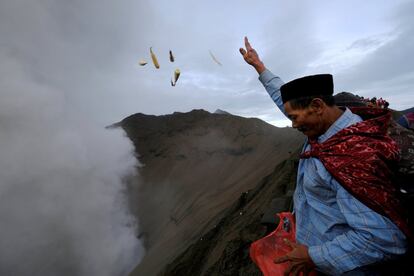 Un adorador lanza ofrendas dentro del cráter del Monte Bromo en Indonesia. La población Tengger practica principalmente la religión hinduista pero incluyen elementos budistas y animistas a su cultura, además del culto a los ancestros.